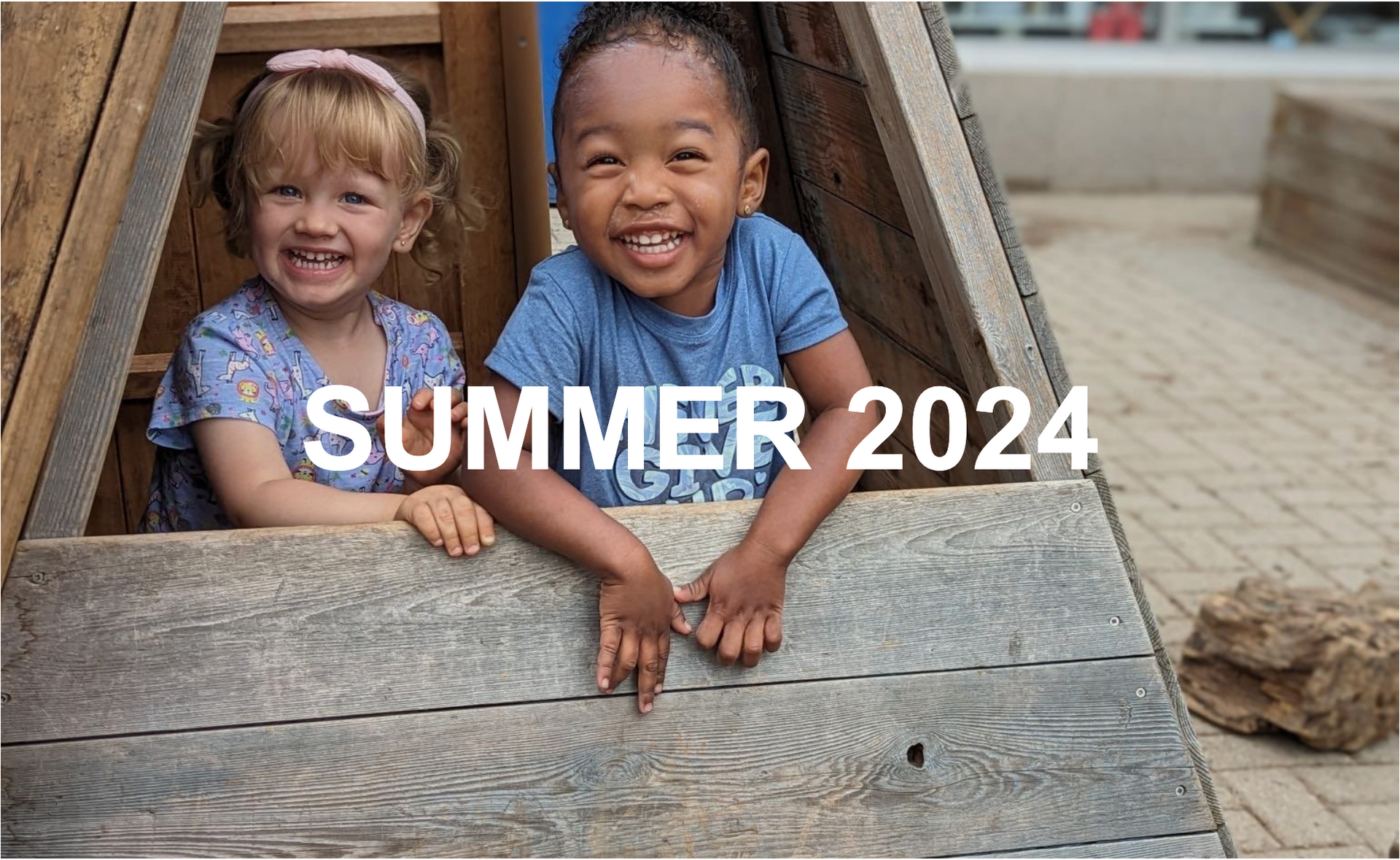 A boy and a girl are playing in a wooden structure.