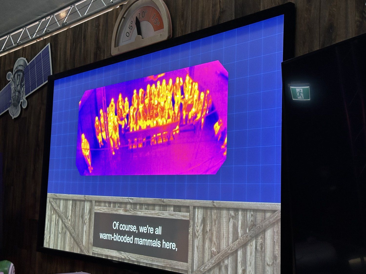 A large screen displays a thermal image of a building