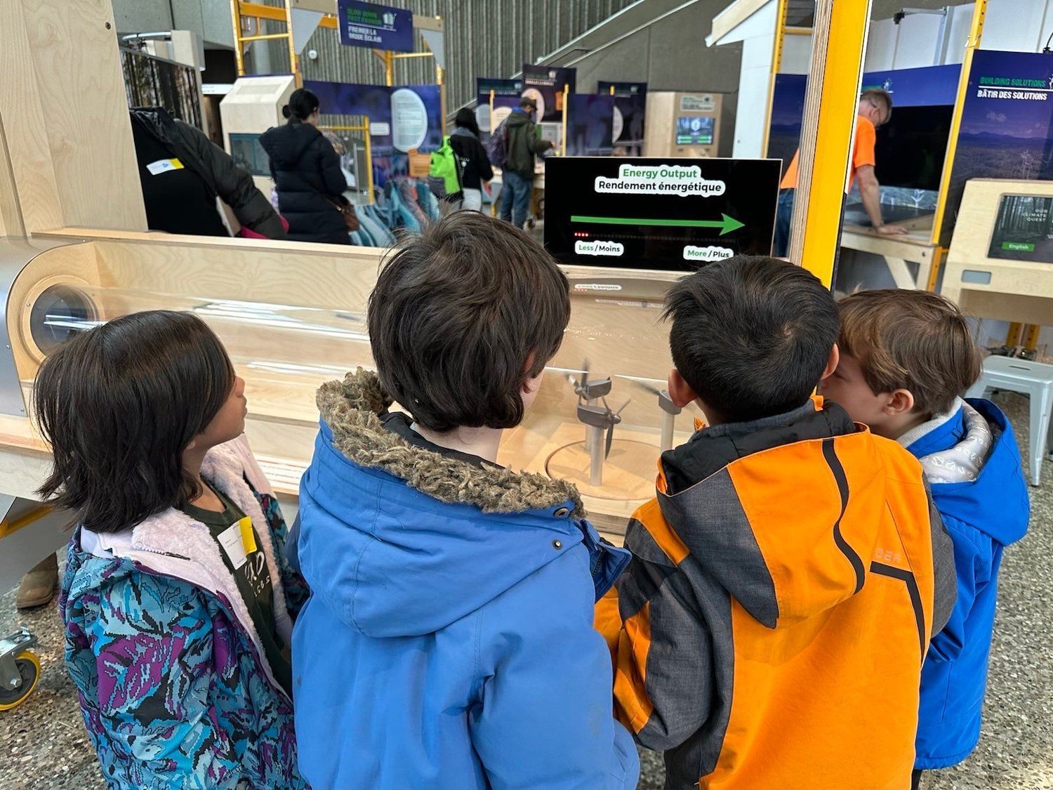 A group of children are looking at a display at a science museum.