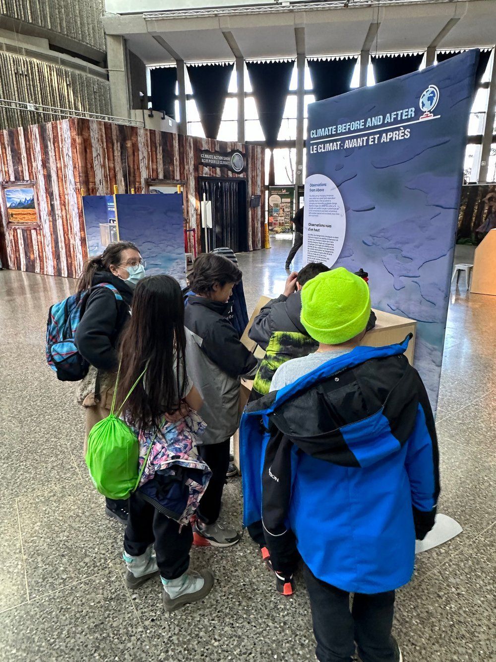 A group of children are standing around a table in a room.