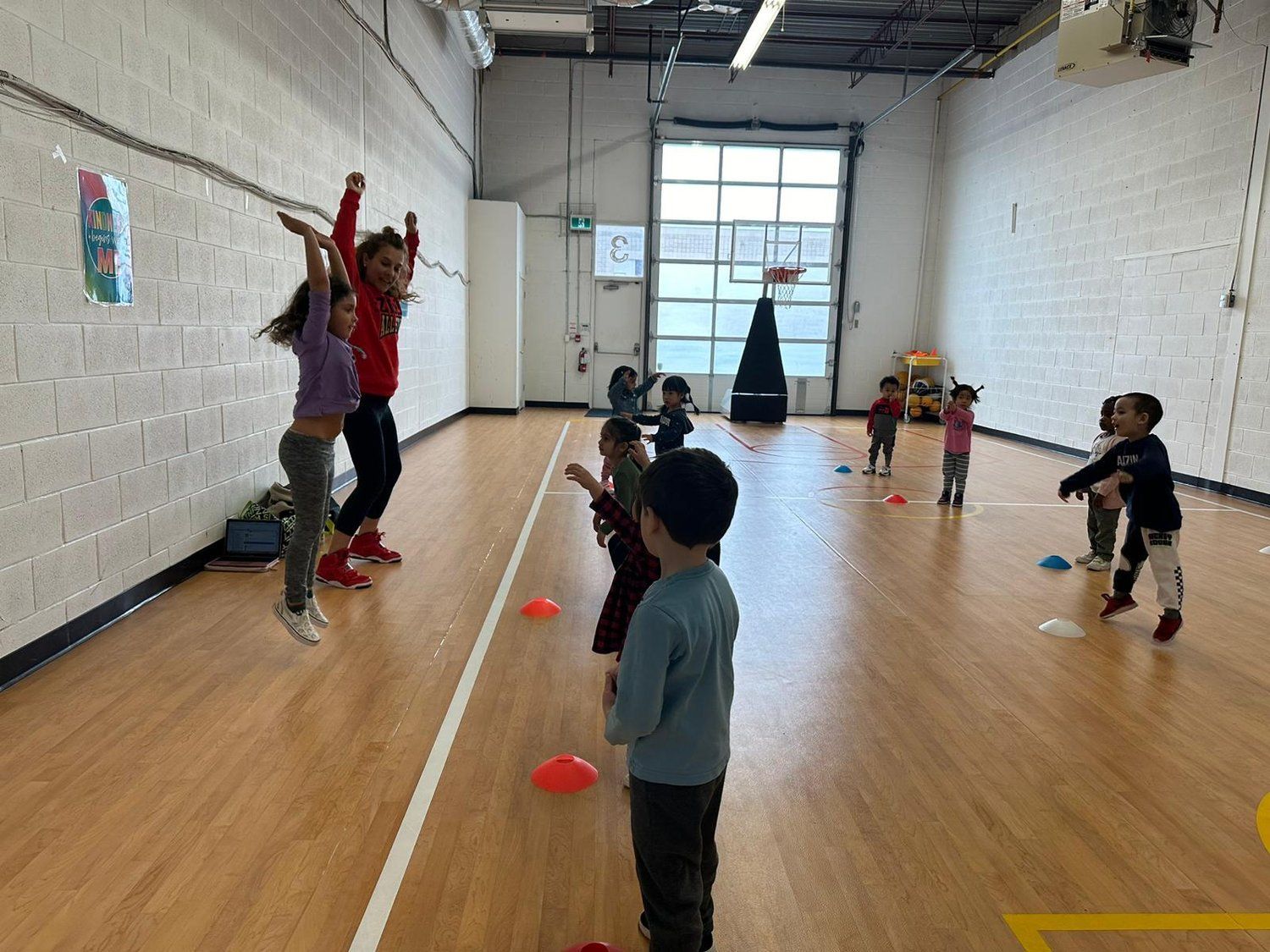 A group of children are playing in a gym.