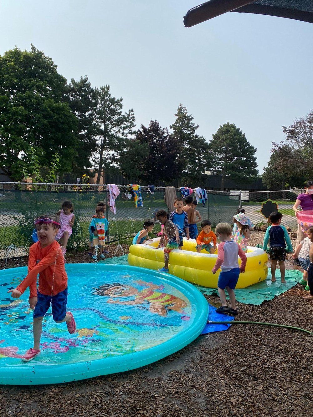 A group of children are playing in a large inflatable pool.