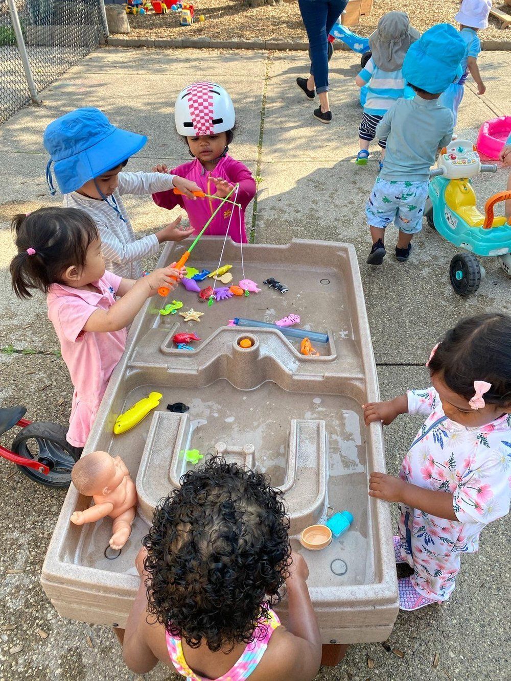 A group of children are playing with toys on a table.