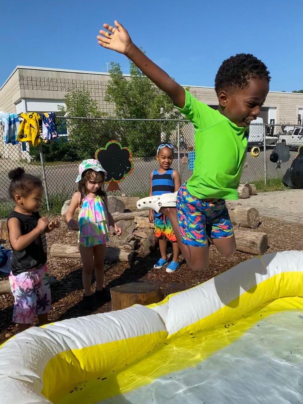 A group of children are playing in an inflatable pool.