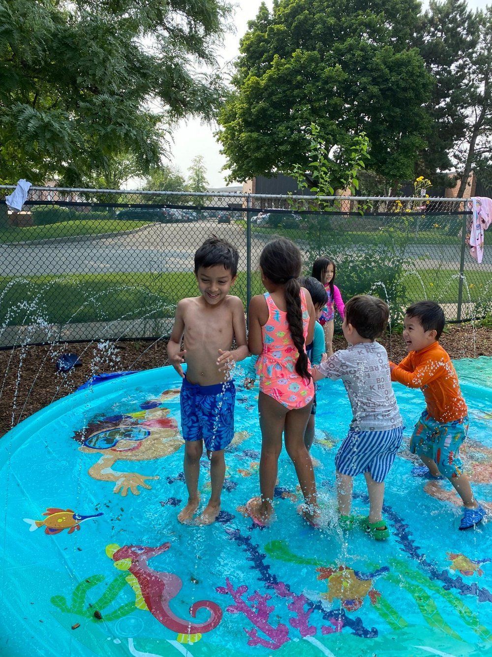 A group of children are playing in an inflatable pool.