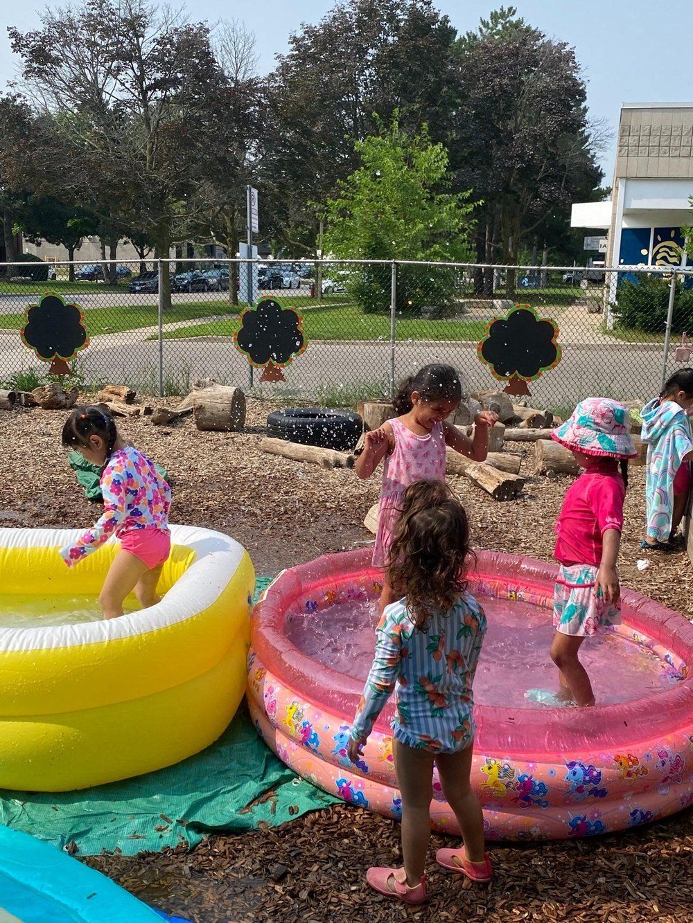 A group of children are playing in an inflatable pool.