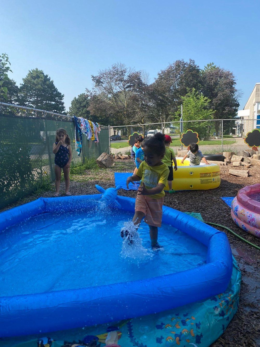 A group of children are playing in an inflatable pool.