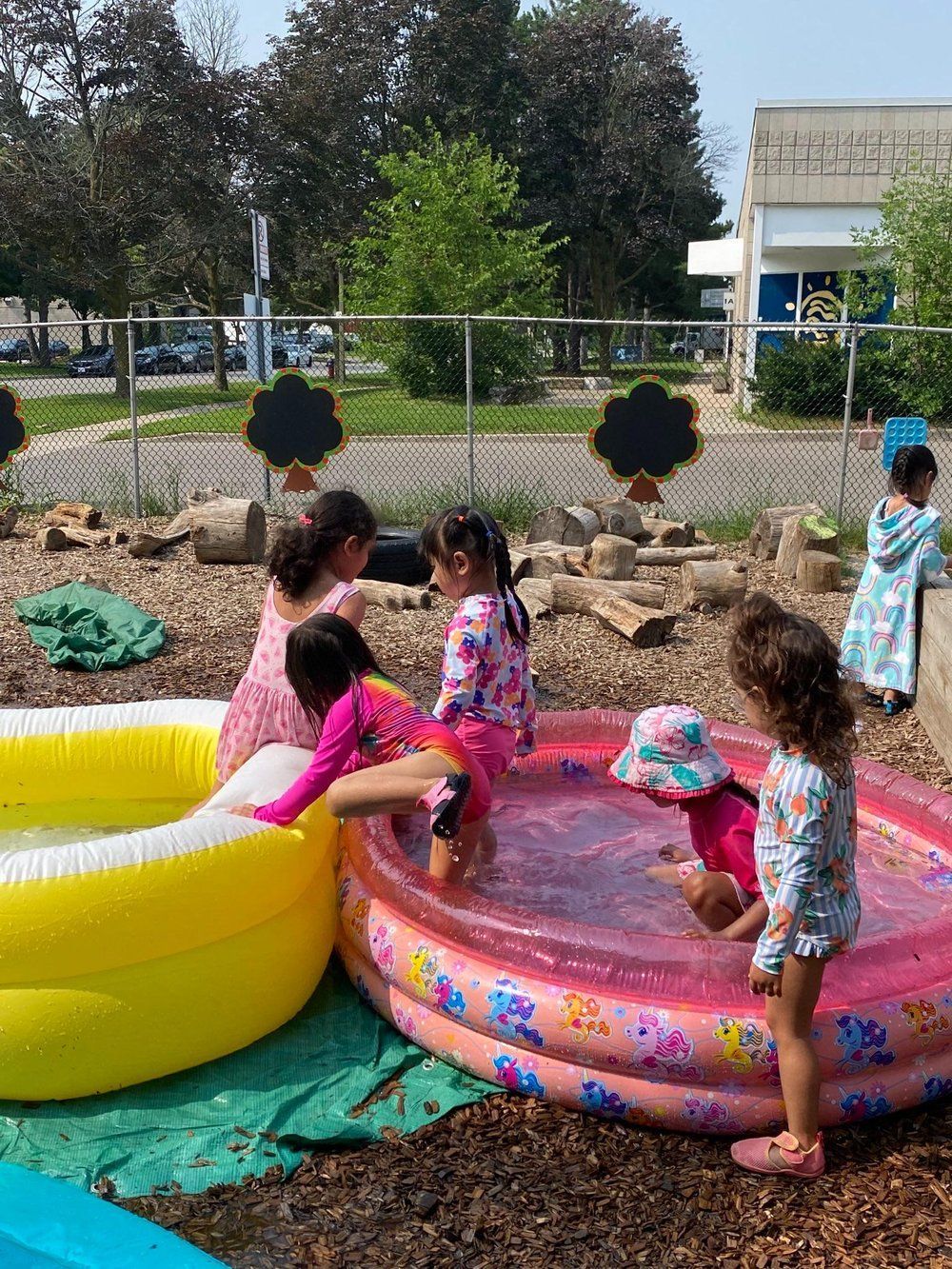 A group of children are playing in an inflatable pool.