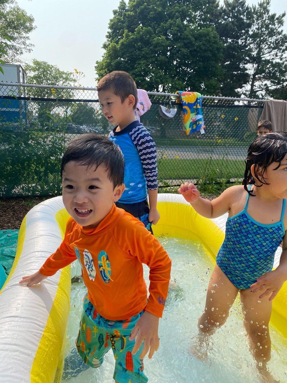A group of children are playing in an inflatable pool.