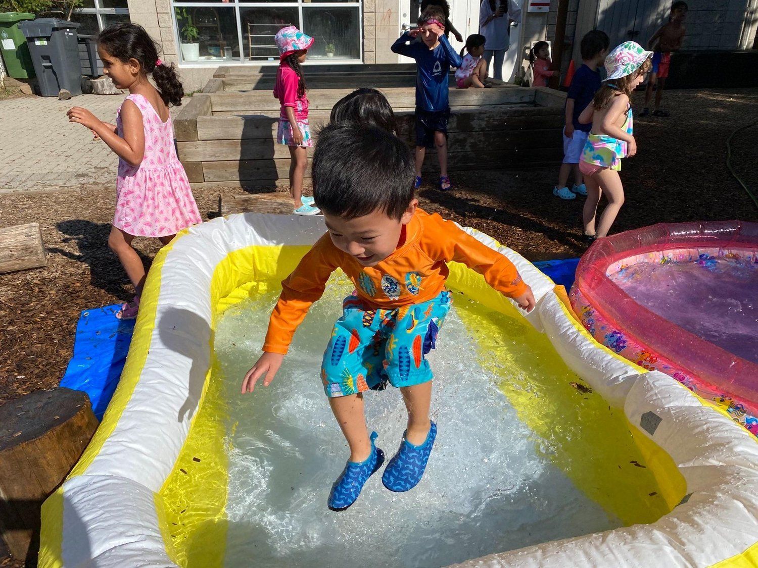 A group of children are playing in an inflatable pool.