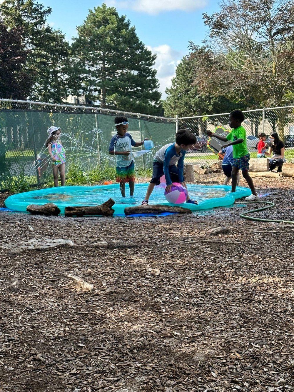 A group of children are playing in a water park.