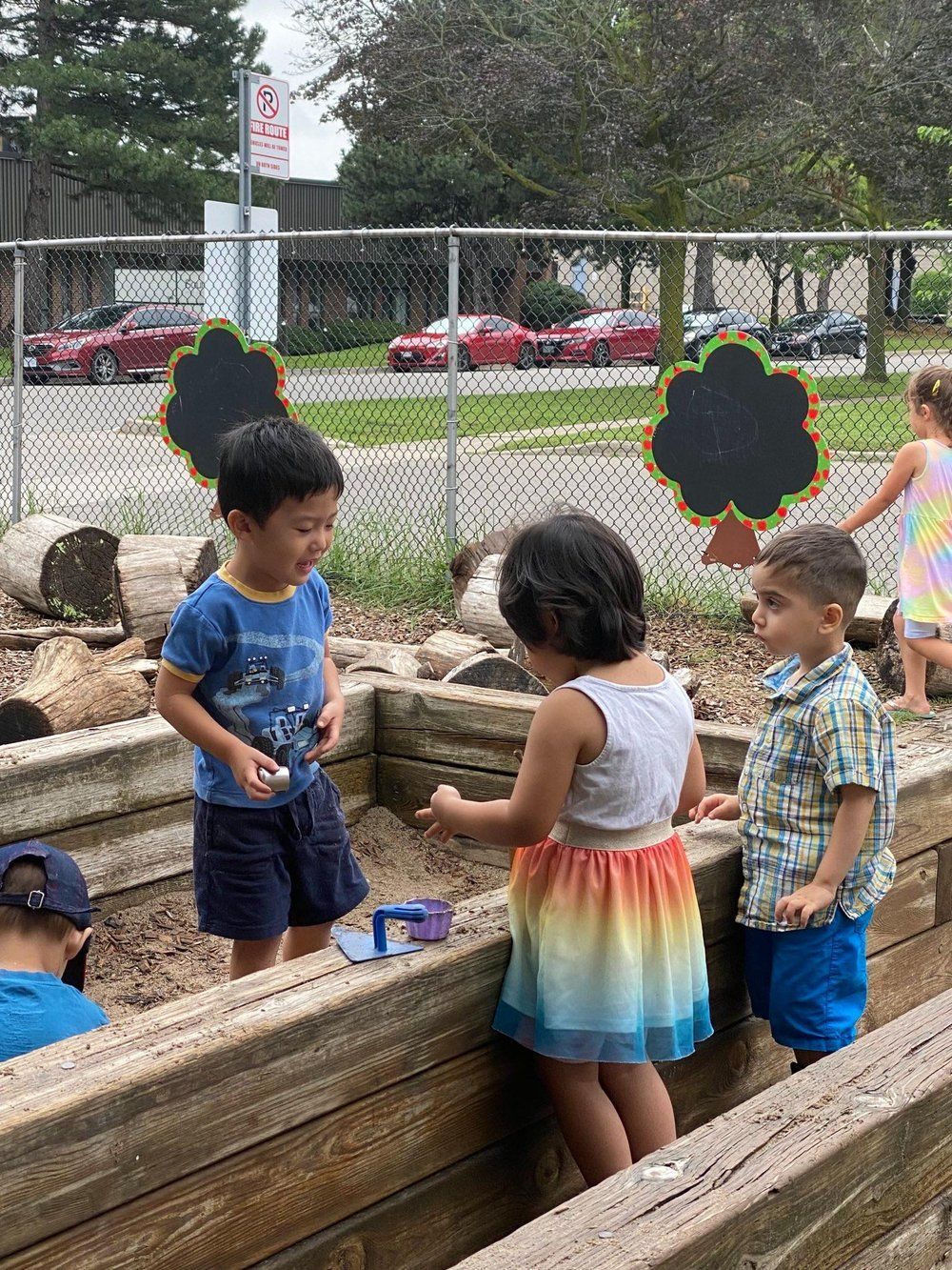 A group of children are playing in a sandbox.