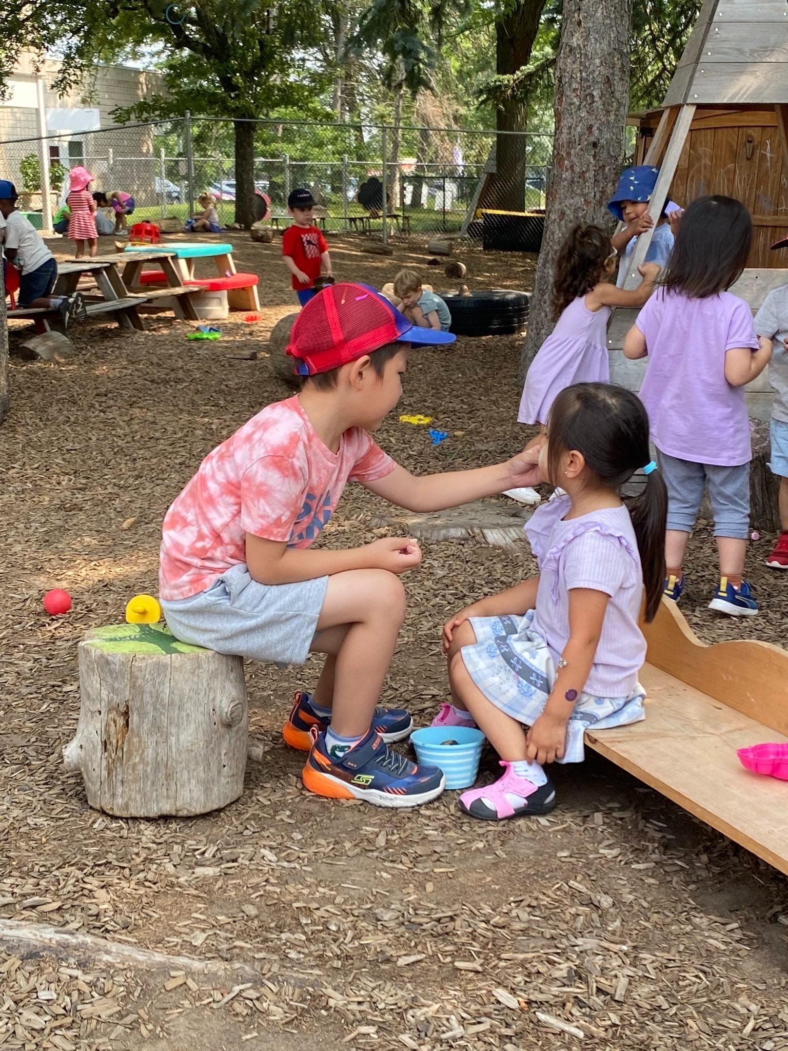 A group of children are playing in the dirt in a park.