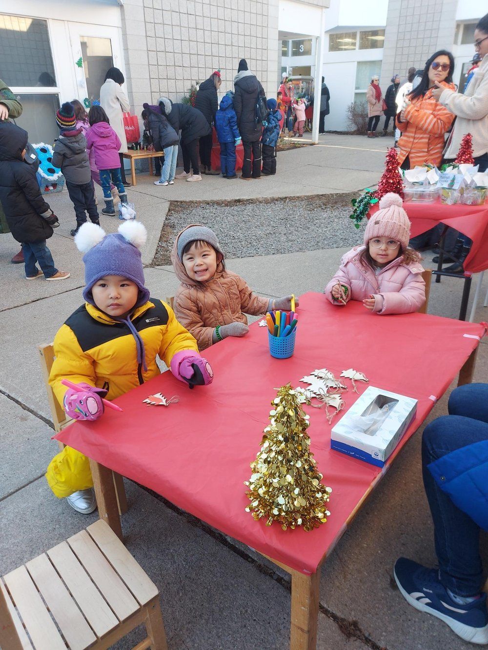 A group of children are sitting at a table decorated for christmas