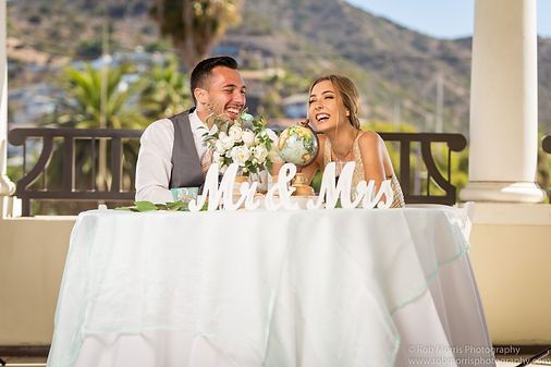 Newlyweds laughing at a table with 