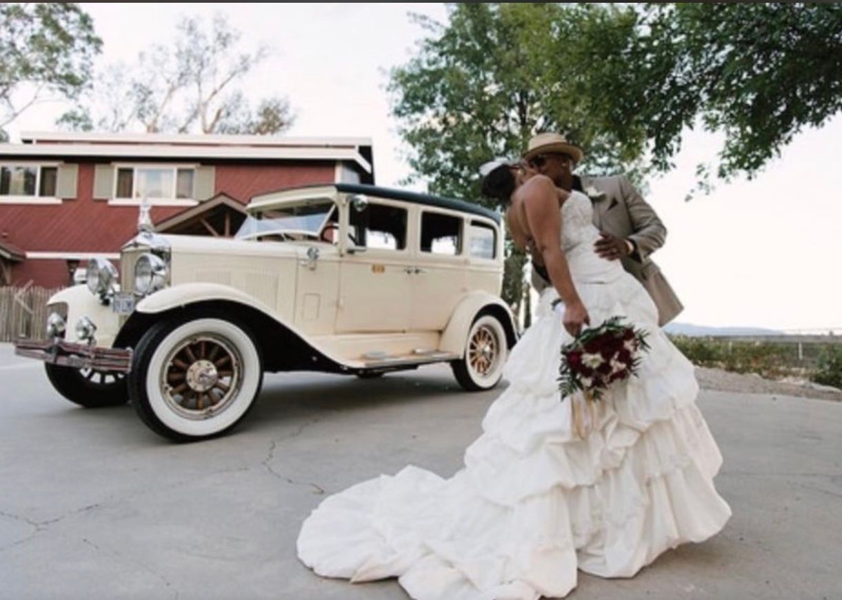 Person served food from a buffet with metal chafing dishes. Pink gloves handle tongs. Other people wait.
