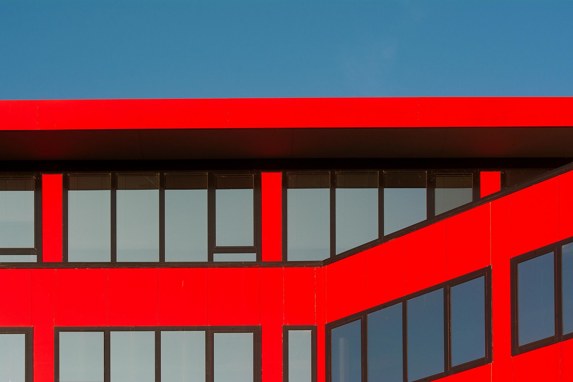 A man is working on a metal pipe on a wall.