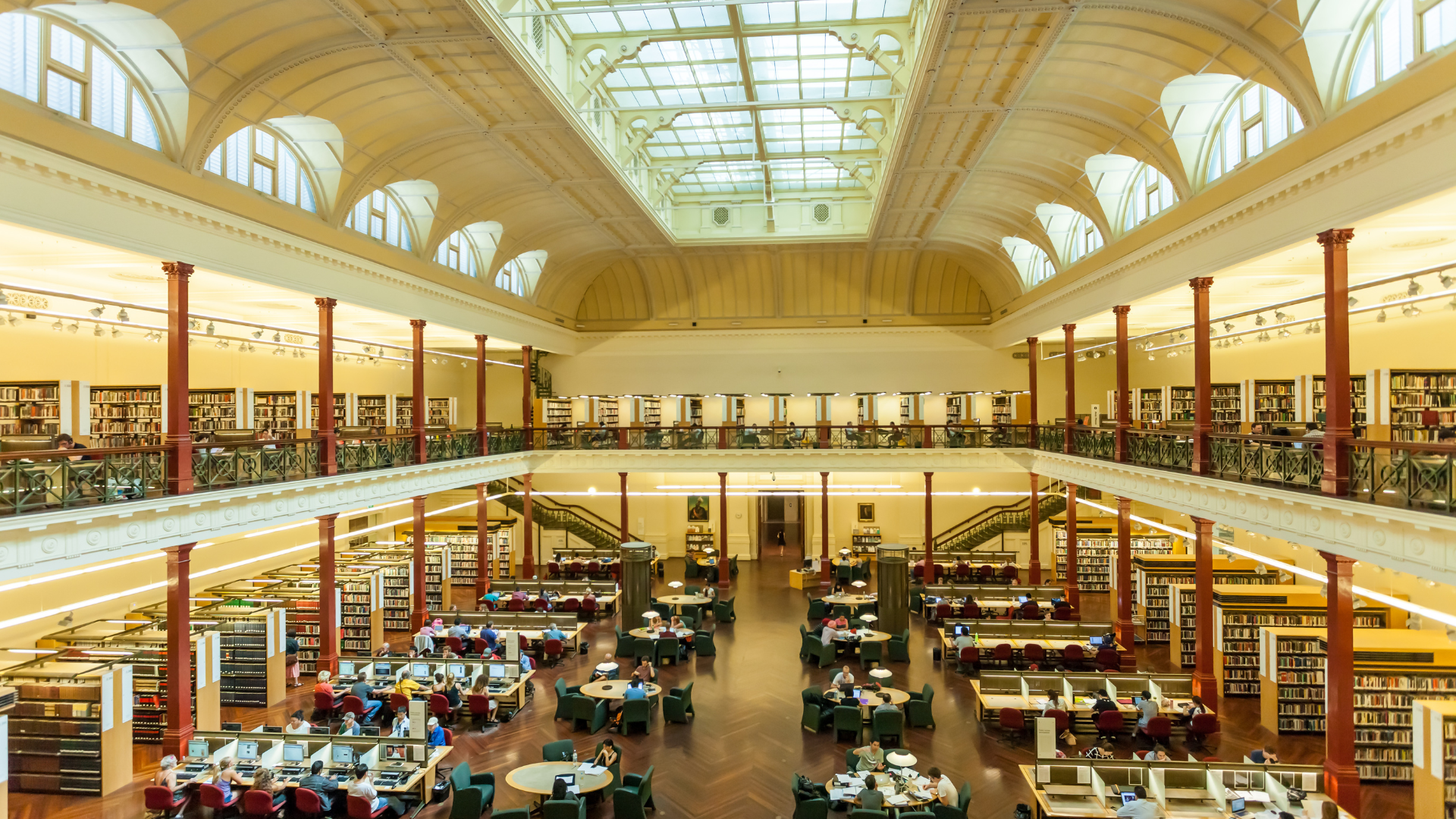 A large library with tables and chairs in it