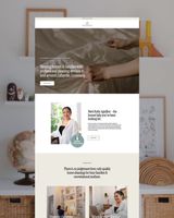 A screenshot of a website showing a woman sitting on a bed.