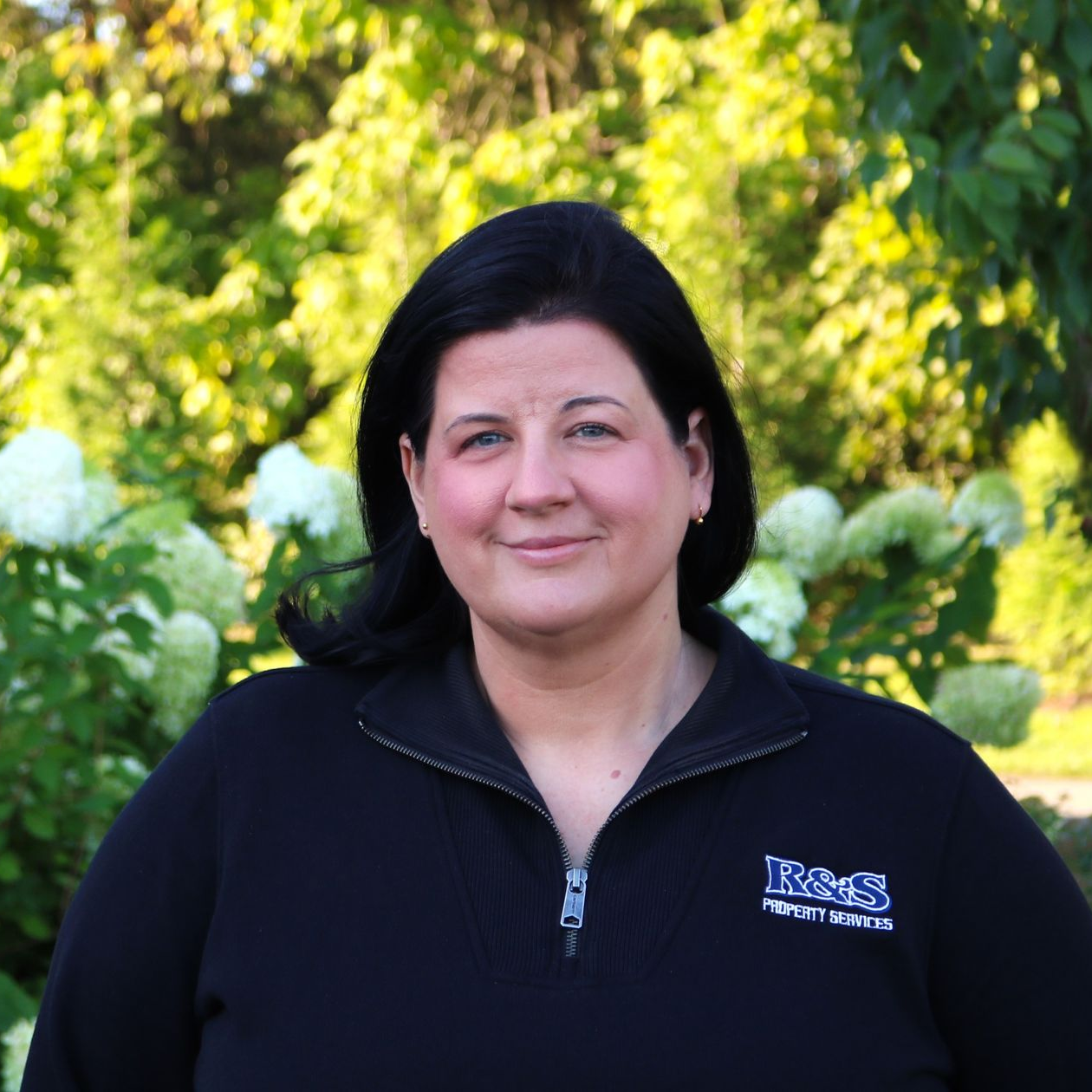 R&S Property Services Team Photo of Young Woman Against Living Grass Wall | Landscape Management Experts