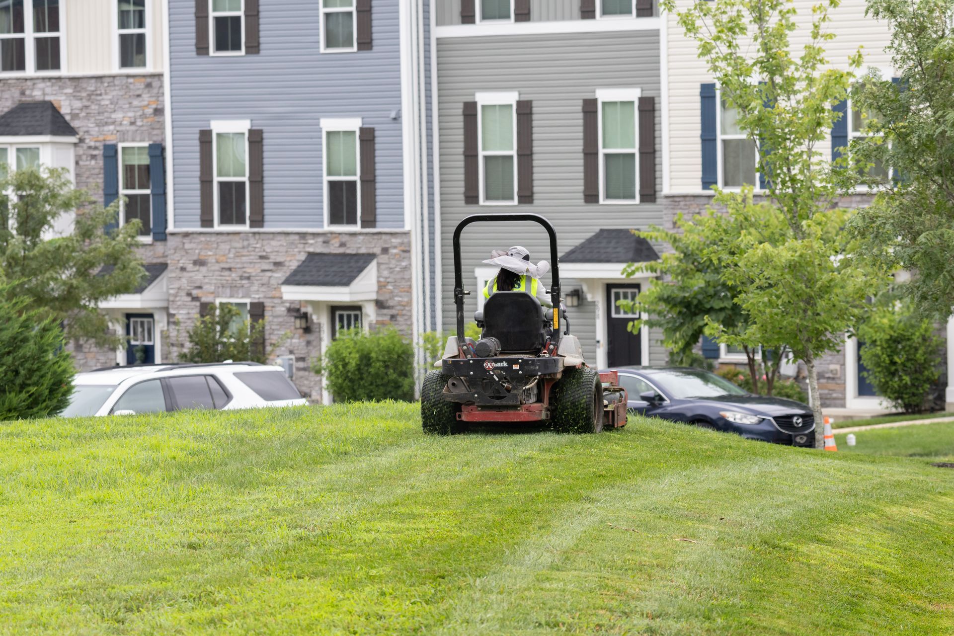 A lawnmower on a large lawn at a townhome complex in Chester County, PA