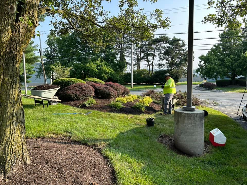 an R&S Property Services landscape maintenance expert mulching a client’s planted beds