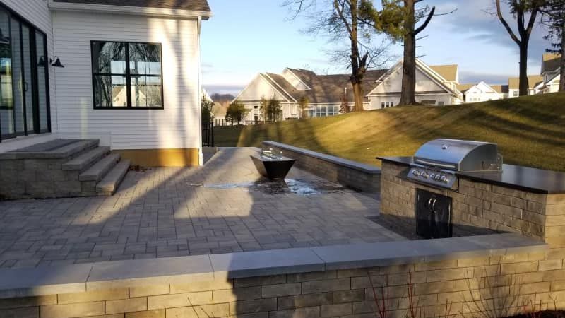 a recently installed patio and outdoor kitchen behind an Exton, PA commercial property