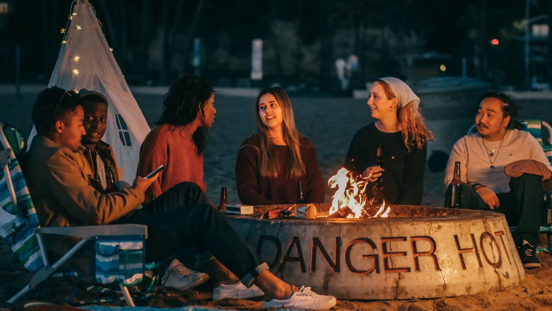 A group of friends spending time together around their custom fire pit in West Chester, PA