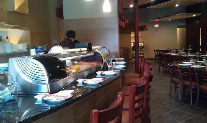 The inside of a restaurant with tables and chairs