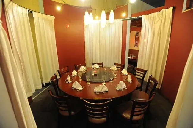 A dining room with a round table and chairs