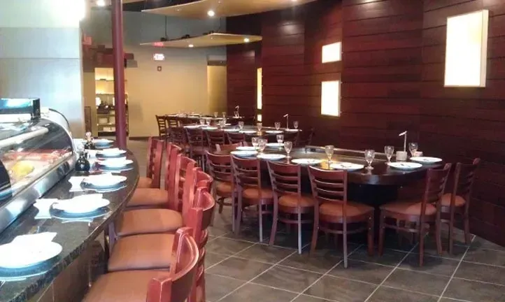 The inside of a restaurant with tables and chairs