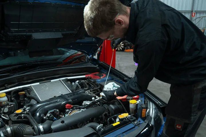 A Man is Working on the Engine of a Car in a Garage — CS Mechanical in Gormans Hill, NSW