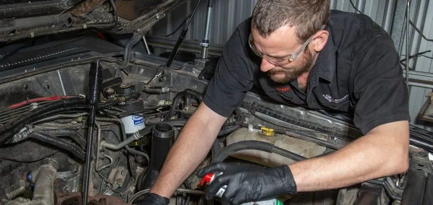 A Man is Working on a Car Engine in a Garage — CS Mechanical in Gormans Hill, NSW