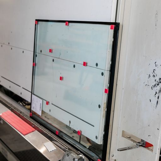 A Large Piece of Glass Is Sitting on A Machine - Buford, GA - EGM Tempering