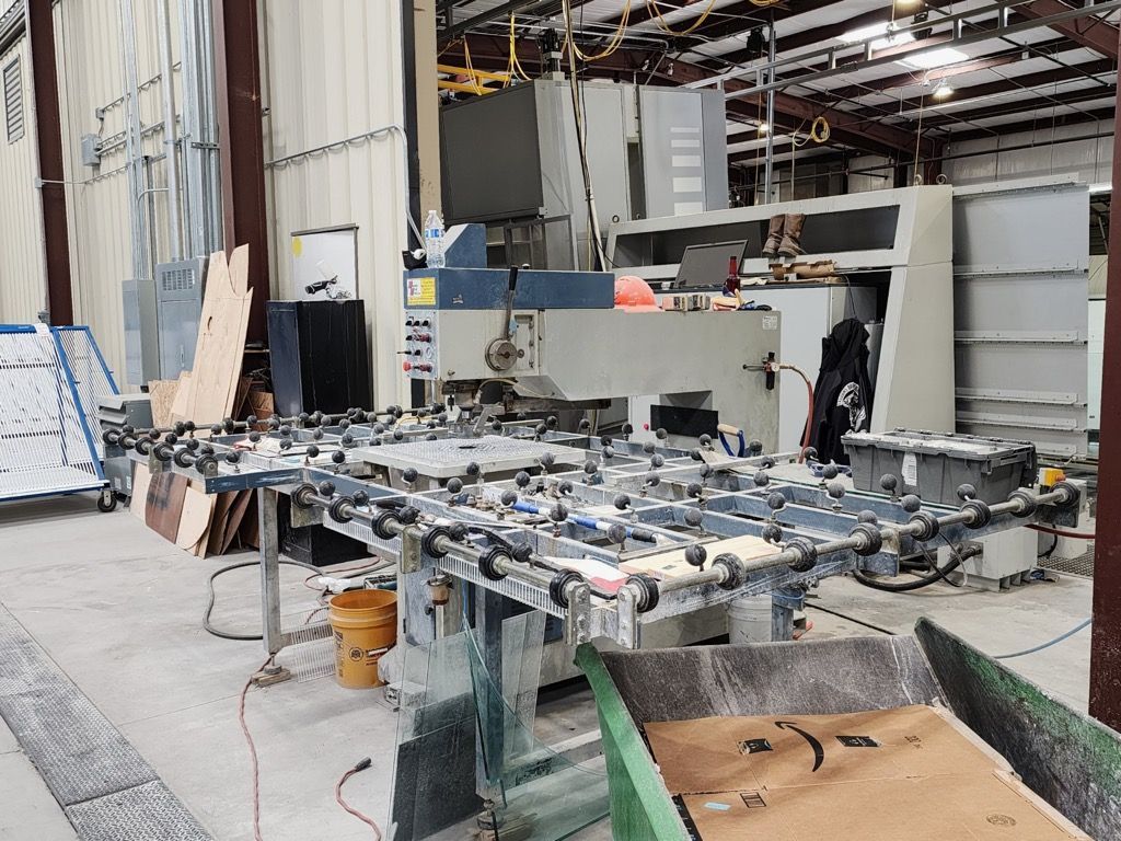 A Machine Is Sitting on A Conveyor Belt in A Factory - Buford, GA - EGM Tempering