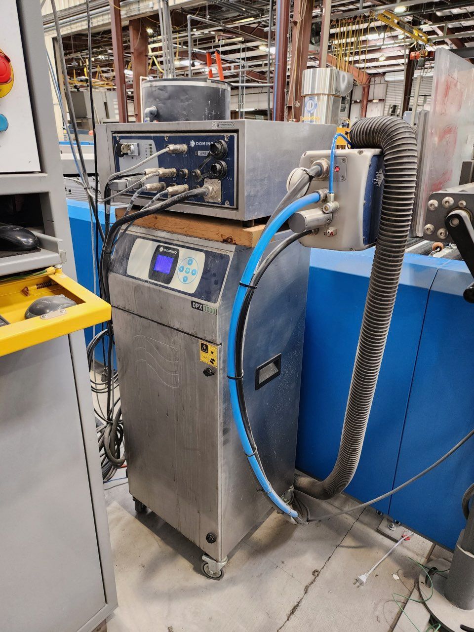 A Machine with A Hose Attached to It in A Factory - Buford, GA - EGM Tempering