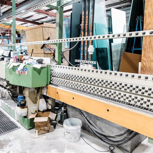 A Machine Is Sitting in A Warehouse Next to A Bucket - Buford, GA - EGM Tempering