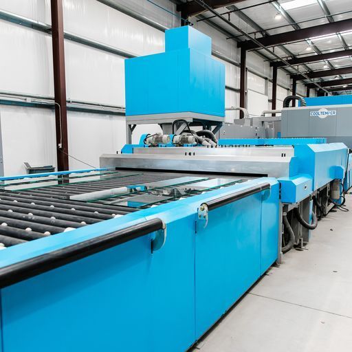 A Large Blue Machine Is Sitting in A Warehouse - Buford, GA - EGM Tempering
