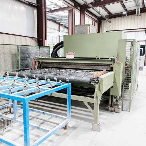 A Machine Is Sitting in A Room with A Lot of Glass on It - Buford, GA - EGM Tempering