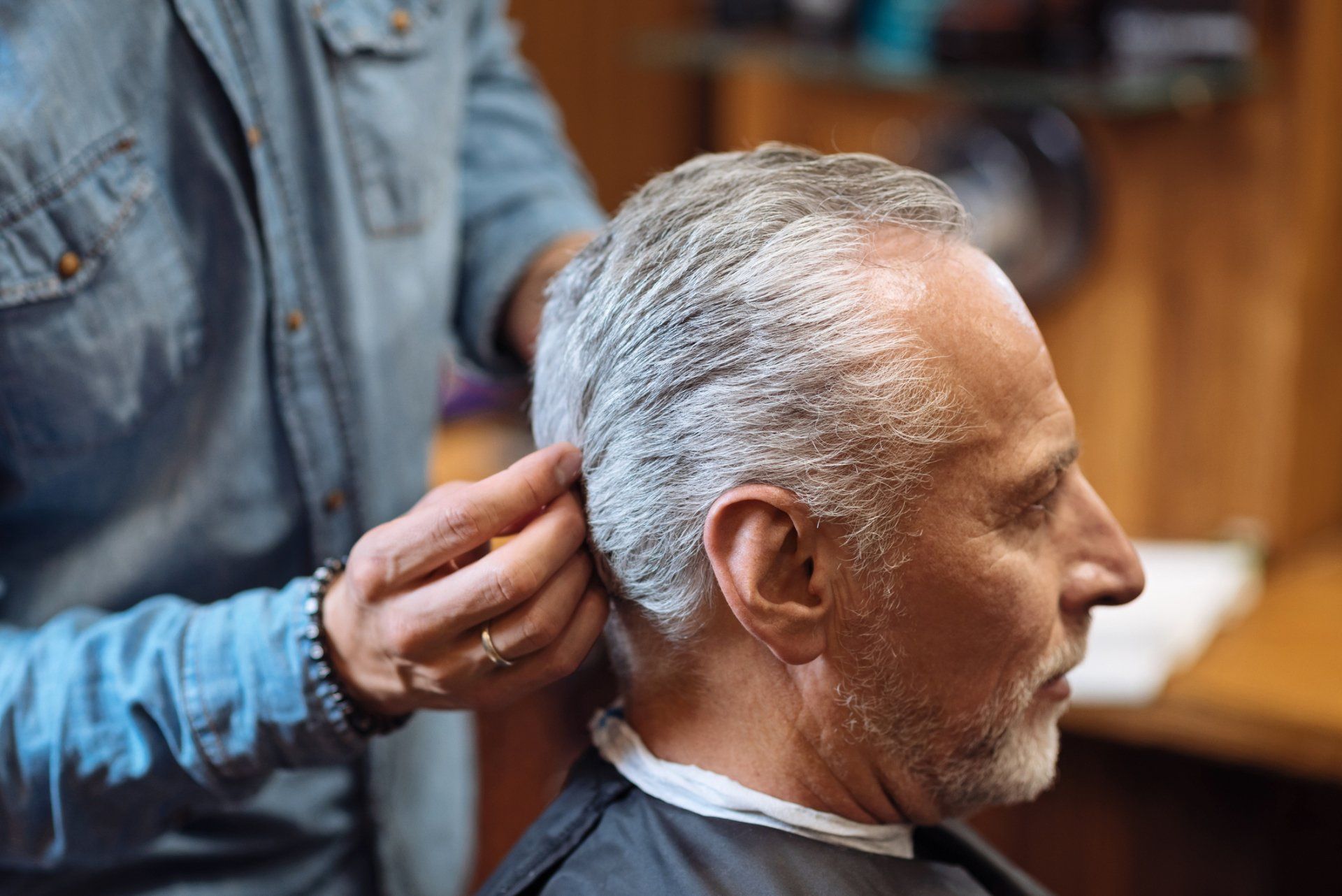 Family Barbershop — Barber Styling Hair of Senior Client in Wilmington, DE
