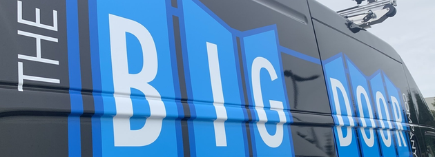 The side of a company vehicle that says The Big Door Company.