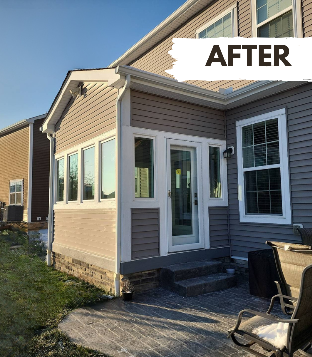 Two-story house with white siding, green doors, and a porch. Brown grass in front, and a brick house to the right.