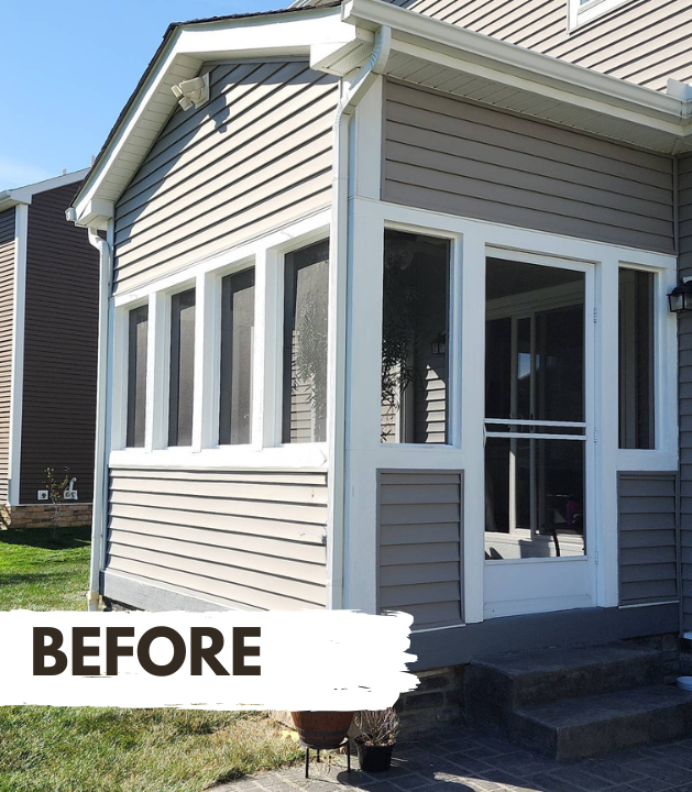 Two-story tan house with porch and dormer. Green lawn and sidewalk in front.