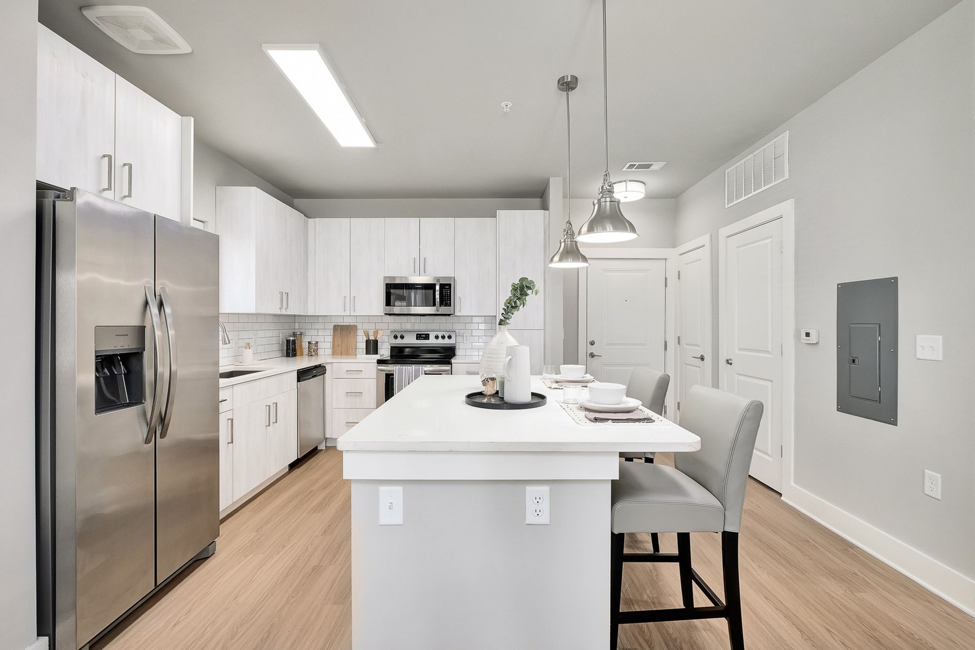 A kitchen with stainless steel appliances and white cabinets
