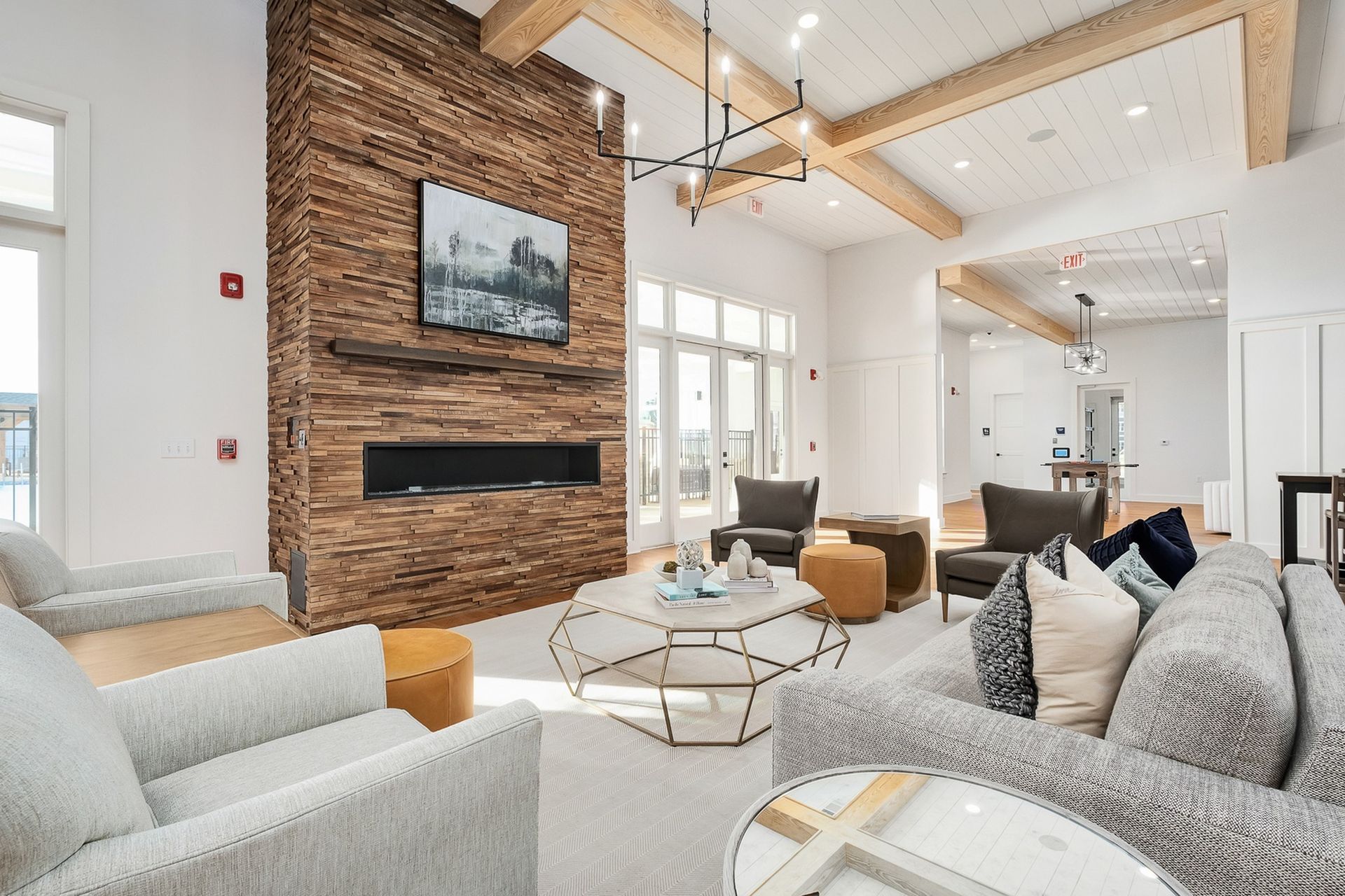 A resident lounge with a couch, chairs, coffee table and television.