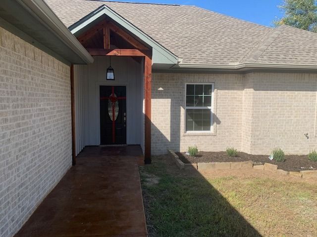 A brick house with a porch and a window