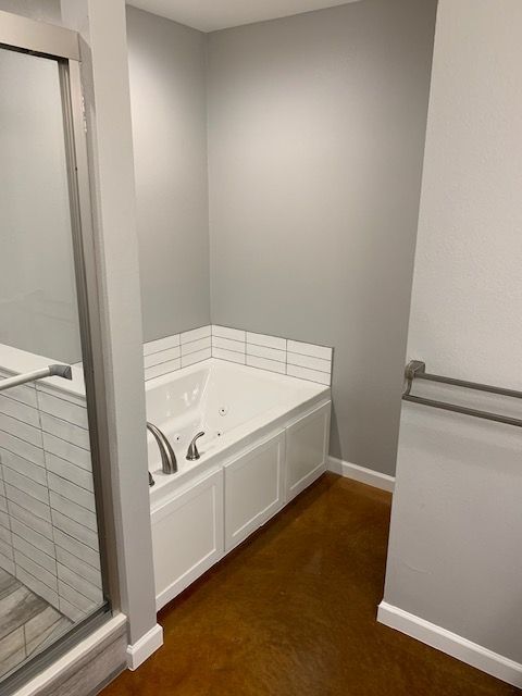 A bathroom with a bathtub and a walk in shower