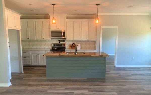 A kitchen with a large island in the middle of the room.