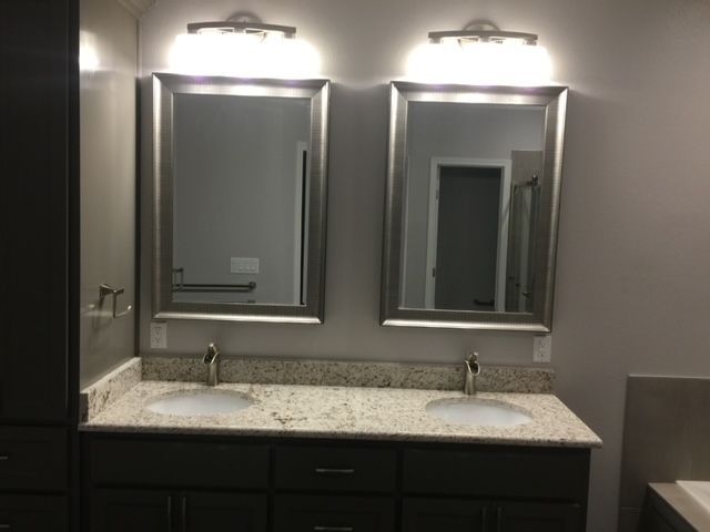 A bathroom with two sinks and two mirrors