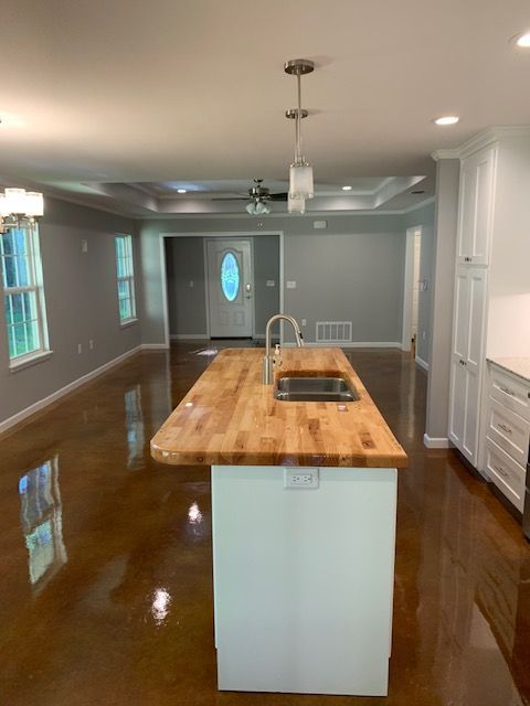 A kitchen with a wooden counter top and two sinks.